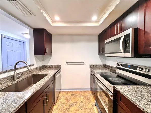 a kitchen with a stove sink and microwave