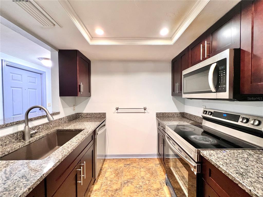 5830 Southwest 9th Place Gainesville, FL 32607 - Photo 8 of 22 a kitchen with a stove sink and microwave