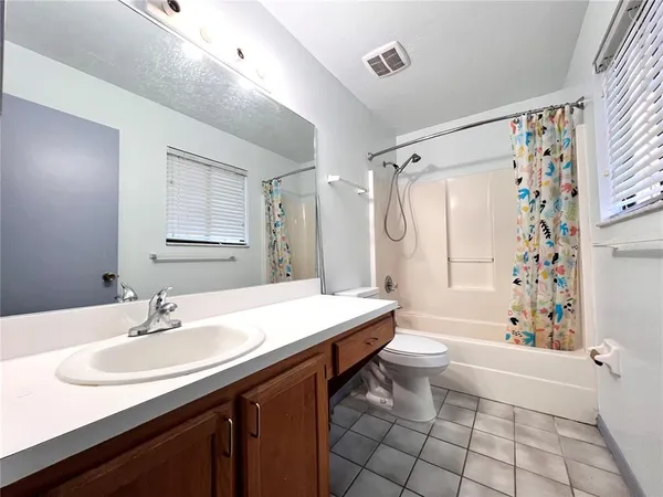 a bathroom with a sink toilet double vanity and bathtub