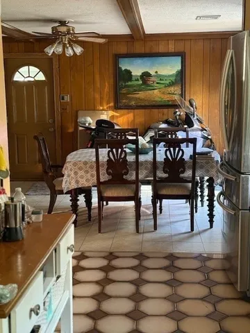 a dining room with furniture and wooden floor