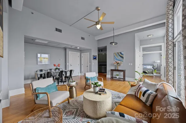 a living room with furniture and wooden floor