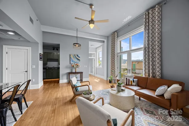 a living room with furniture and wooden floor