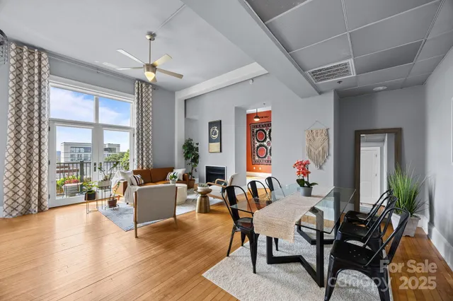 a view of a livingroom with furniture window and wooden floor