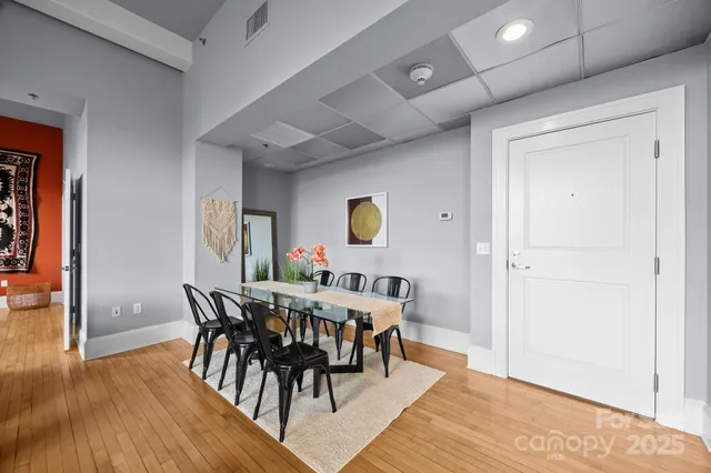 a view of a dining room with furniture and wooden floor