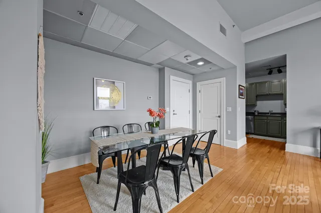 a view of a dining room with furniture and wooden floor