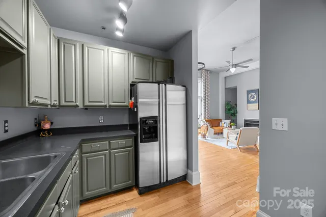 a kitchen with granite countertop a refrigerator and a sink