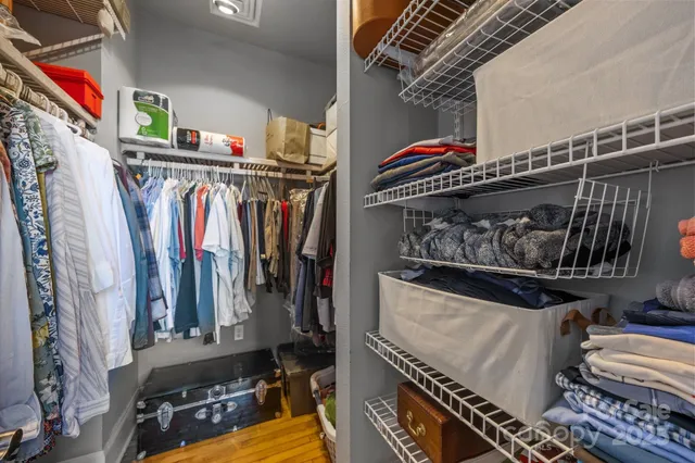 a view of walk in closet with clothes