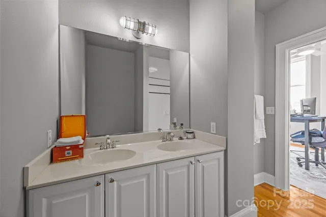 a bathroom with a sink vanity and a mirror