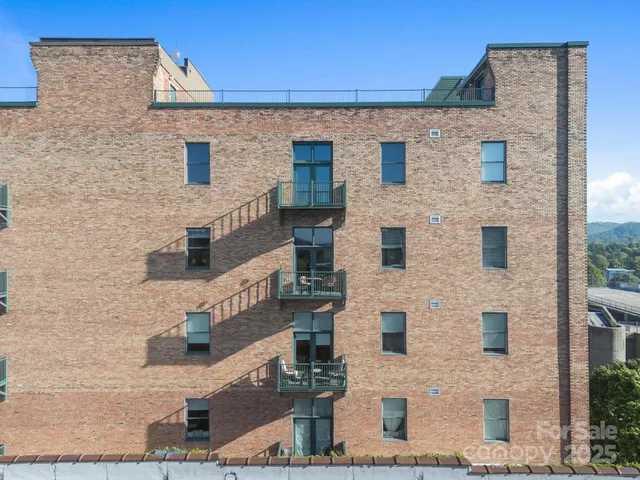 an aerial view of residential building with green space