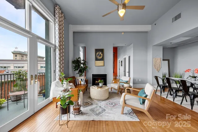 a living room with fireplace furniture and a wooden floor