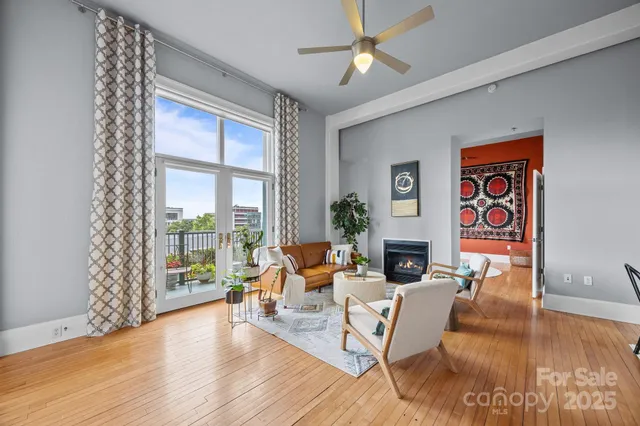 a living room with fireplace furniture and a wooden floor
