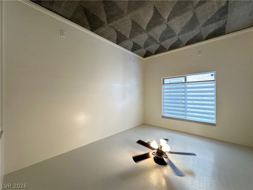 6784 Pivot Point Street Las Vegas, NV 89148 - Photo 17 of 27 An empty room features a textured ceiling, a window, and a ceiling fan.