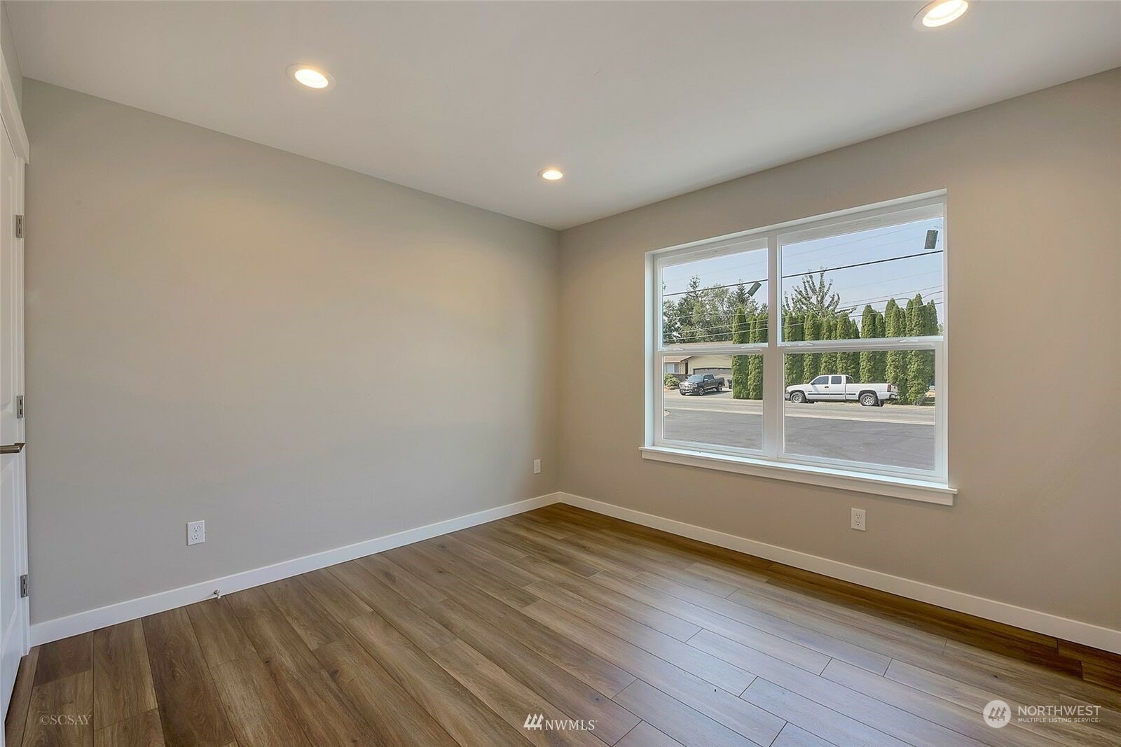 808 Nooksack Road Nooksack, WA 98276 - Photo 8 of 9 an empty room with wooden floor and windows