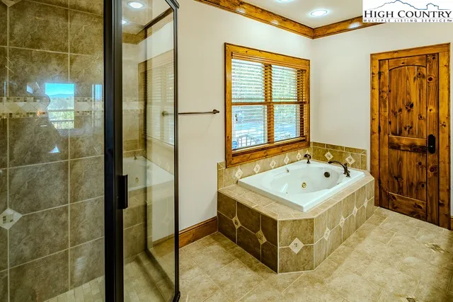 a bathroom with a tub and a shower