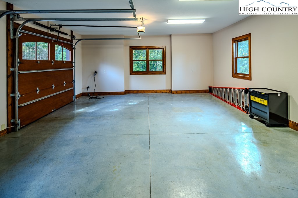 236 Stack Rock Road Elk Park, NC 28622 - Photo 16 of 50 a view of an empty room with a window and furniture