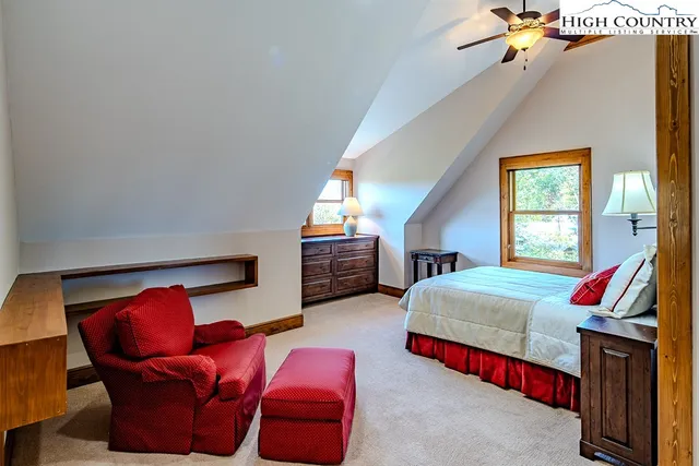 a bedroom with furniture and a potted plant