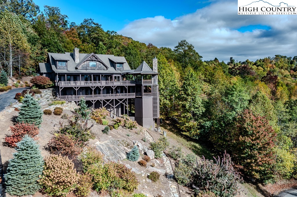 236 Stack Rock Road Elk Park, NC 28622 - Photo 37 of 50 a view of a big house with a big yard and large trees