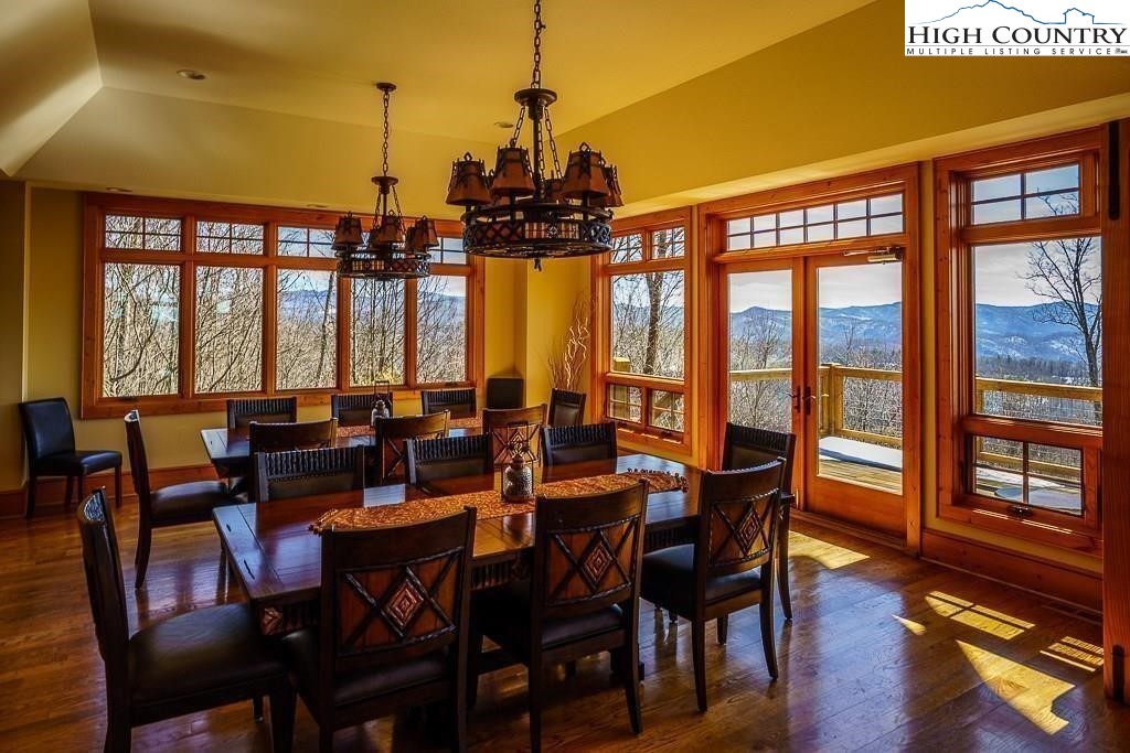 236 Stack Rock Road Elk Park, NC 28622 - Photo 47 of 50 a view of a dining room with furniture window and wooden floor