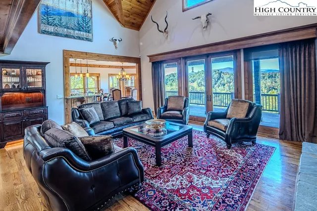 a living room with furniture and a floor to ceiling window