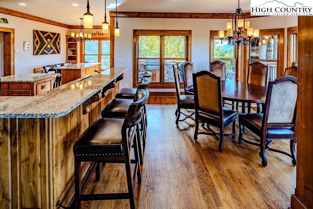 236 Stack Rock Road Elk Park, NC 28622 - Photo 7 of 50 a dining room with furniture and wooden floor
