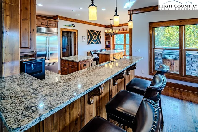 a view of living room kitchen with furniture and flat screen tv