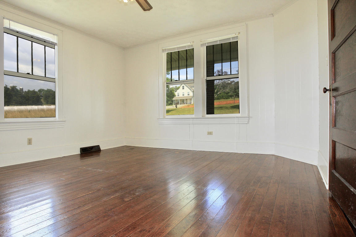 390 Kemp Ford Road Union Hall, VA 24176 - Photo 20 of 47 an empty room with wooden floor and windows