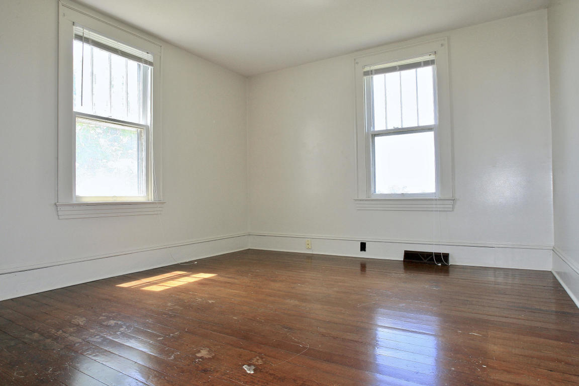 390 Kemp Ford Road Union Hall, VA 24176 - Photo 23 of 47 an empty room with wooden floor and windows