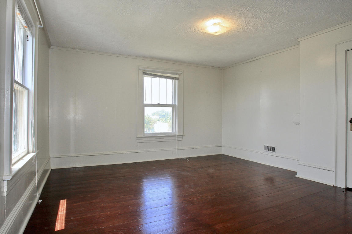 390 Kemp Ford Road Union Hall, VA 24176 - Photo 28 of 47 an empty room with wooden floor and windows