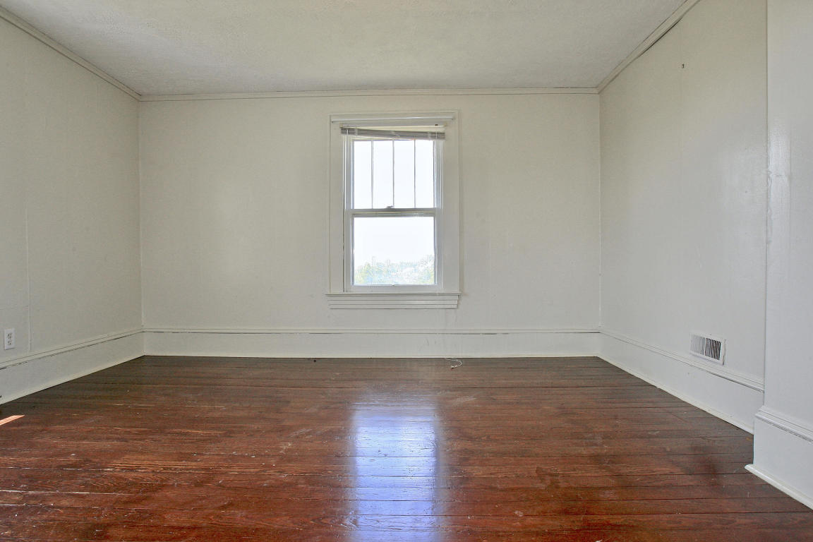 390 Kemp Ford Road Union Hall, VA 24176 - Photo 29 of 47 an empty room with wooden floor and windows