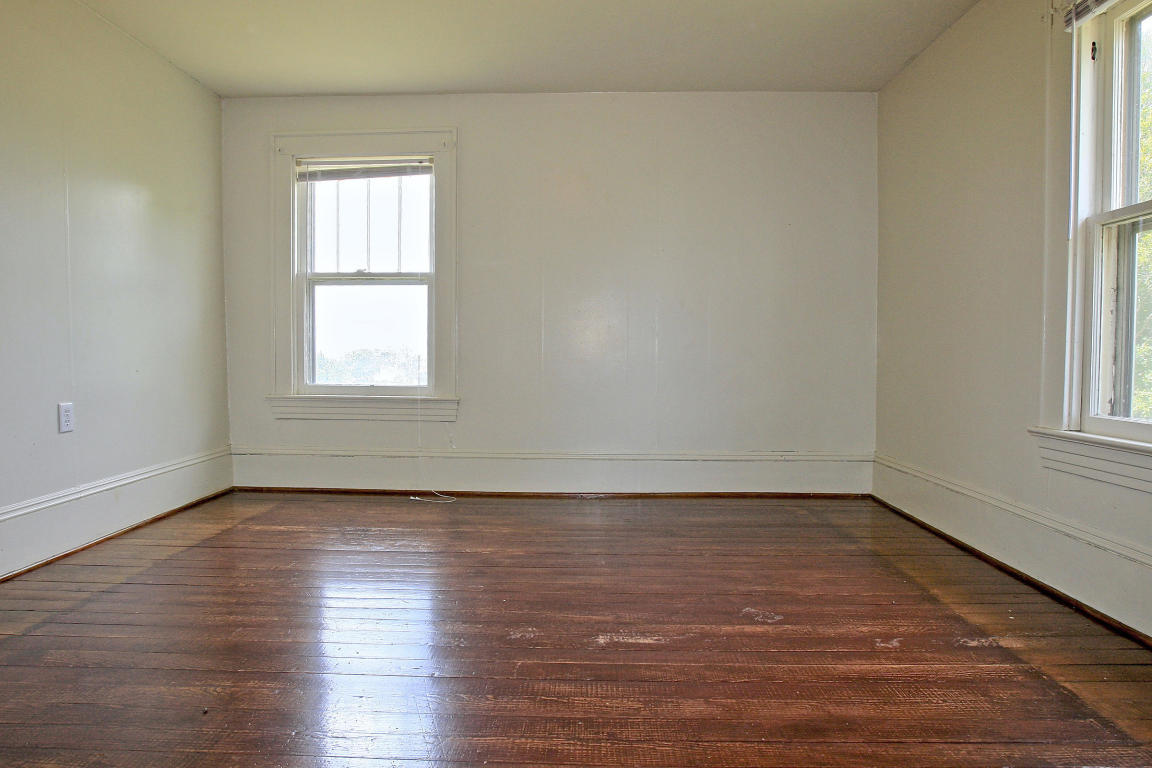 390 Kemp Ford Road Union Hall, VA 24176 - Photo 32 of 47 an empty room with wooden floor and windows