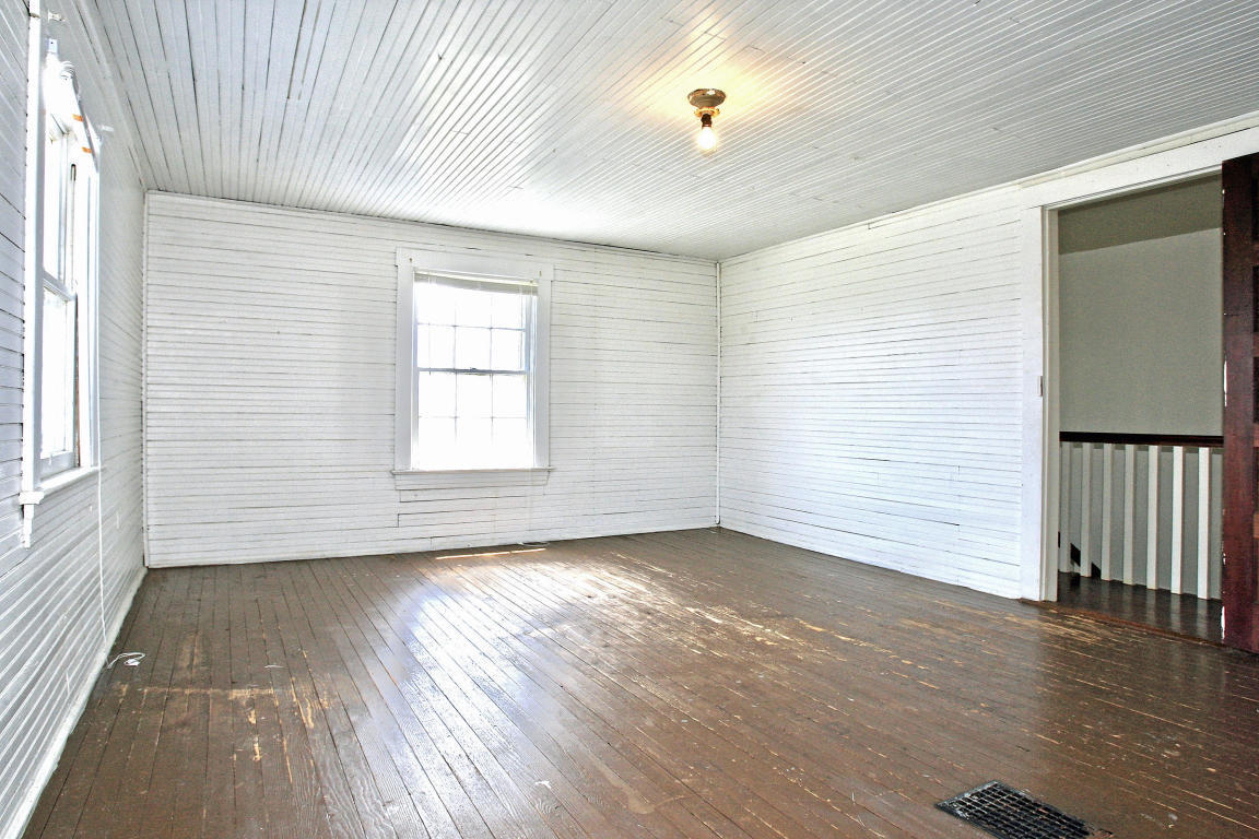 390 Kemp Ford Road Union Hall, VA 24176 - Photo 34 of 47 an empty room with wooden floor and windows