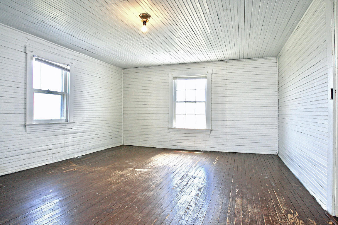 390 Kemp Ford Road Union Hall, VA 24176 - Photo 36 of 47 an empty room with wooden floor and windows