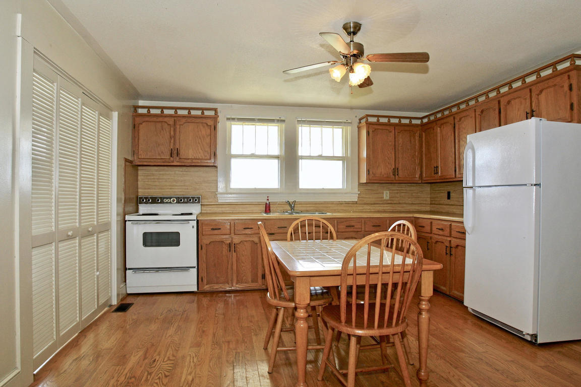 390 Kemp Ford Road Union Hall, VA 24176 - Photo 10 of 47 a kitchen with stainless steel appliances granite countertop a stove a refrigerator a sink a dining table and chairs with wooden floor