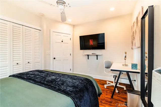 a bedroom with a bed and a refrigerator