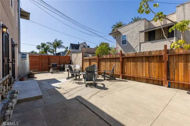a view of backyard with wheel chair potted plants and large tree