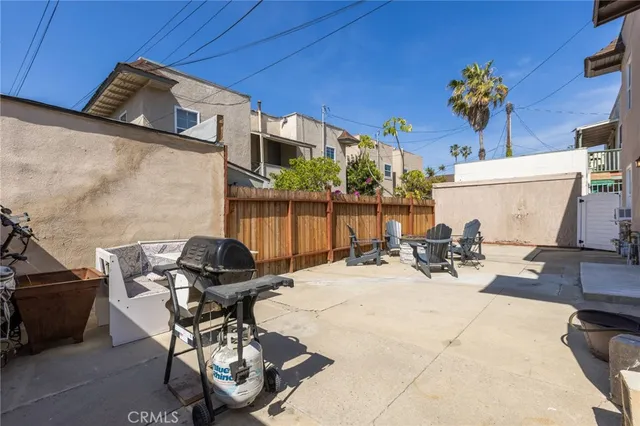 a view of a patio with table and chairs and potted plants