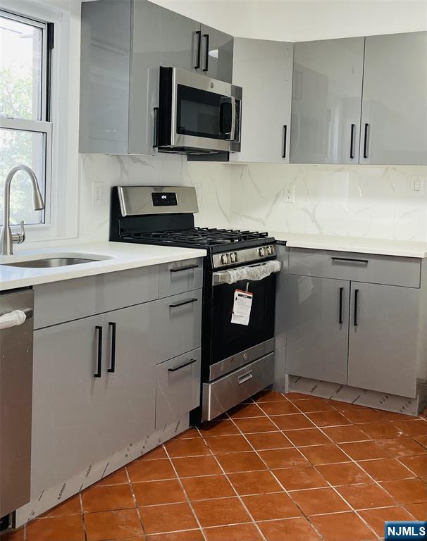 303 North 3rd Street, Unit 1 Harrison, NJ 07029 - Photo 2 of 11 a kitchen with a sink stove and microwave
