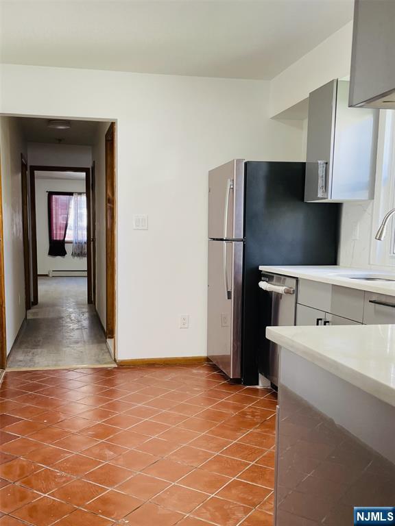 303 North 3rd Street, Unit 1 Harrison, NJ 07029 - Photo 3 of 11 a kitchen with stainless steel appliances a refrigerator and a stove
