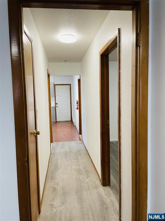 303 North 3rd Street, Unit 1 Harrison, NJ 07029 - Photo 4 of 11 a view of a hallway with wooden floor