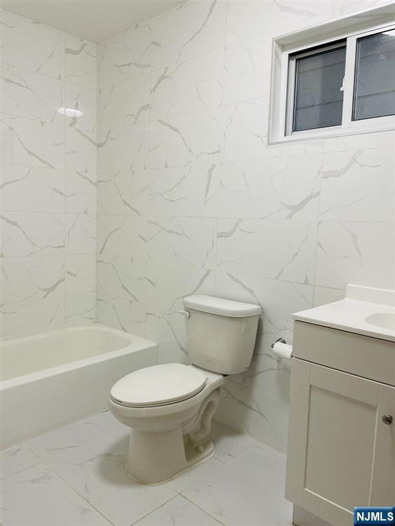 303 North 3rd Street, Unit 1 Harrison, NJ 07029 - Photo 7 of 11 a white toilet sitting next to a bath tub