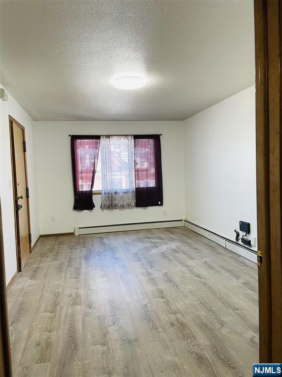 303 North 3rd Street, Unit 1 Harrison, NJ 07029 - Photo 9 of 11 an empty room with windows and entrance