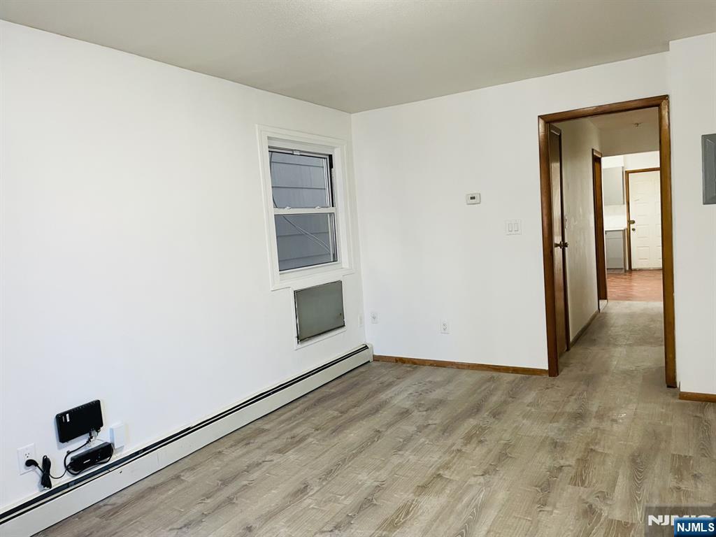 303 North 3rd Street, Unit 1 Harrison, NJ 07029 - Photo 10 of 11 an empty room with windows