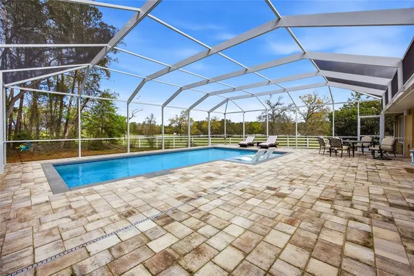 a view of yard with swimming pool and green space