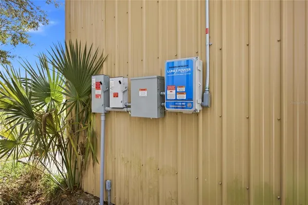 a view of a room with wooden floor and potted plant