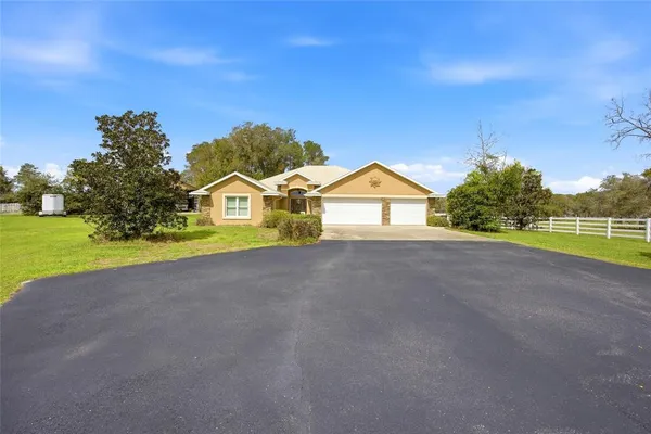 a living room with furniture a ceiling fan and a window