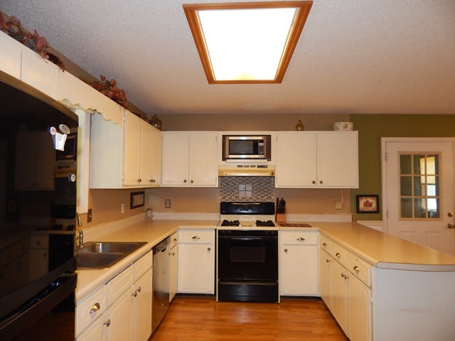 826 McKay Road Gray, GA 31032 - Photo 11 of 28 a kitchen with stainless steel appliances granite countertop a stove a sink and a refrigerator