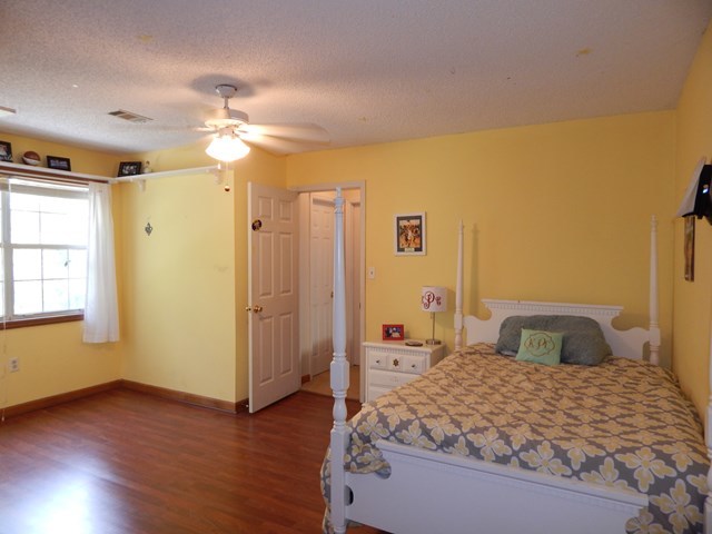 826 McKay Road Gray, GA 31032 - Photo 17 of 28 a bedroom with a bed and wooden floor