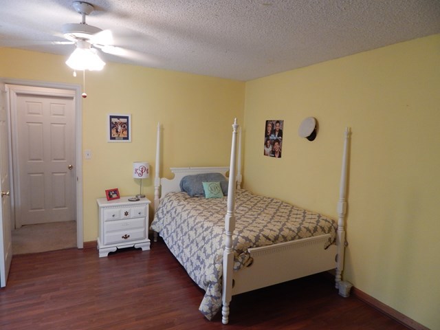 826 McKay Road Gray, GA 31032 - Photo 18 of 28 a bedroom with a bed and a chandelier