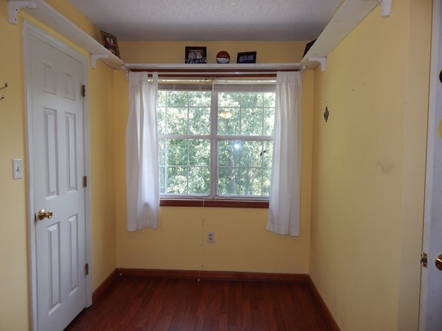 826 McKay Road Gray, GA 31032 - Photo 19 of 28 a view of an empty room with wooden floor and a window
