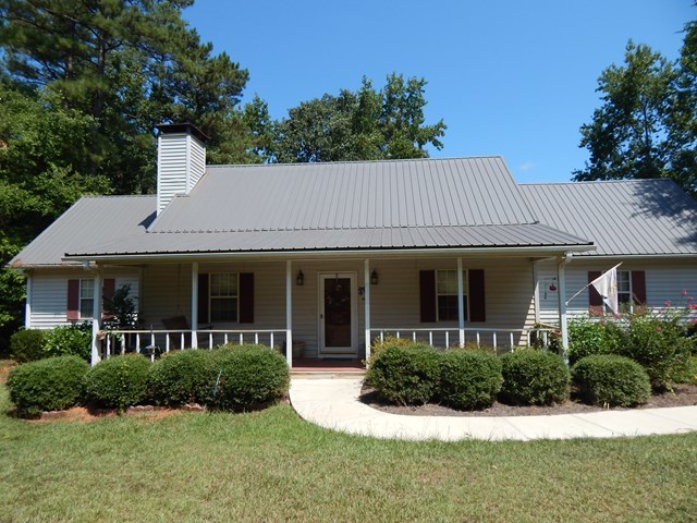 826 McKay Road Gray, GA 31032 - Photo 3 of 28 a view of a white house with a yard and potted plants